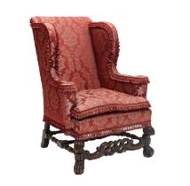 A William & Mary-Style Wing-Back Armchair, late 19th/early 20th century, recovered in red floral