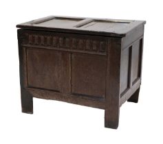 A Late 17th Century Joined Oak Chest, the hinged lid with fielded panels enclosing a later fabric-