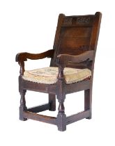 A 17th Century Joined Oak Wainscot-Type Armchair, initialled EB and dated 1696, the panelled back