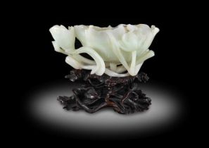 ~ A Chinese White Jade Brush Washer, Qing Dynasty, late 18th/19th century, carved as a lotus leaf
