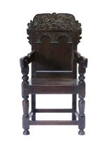 A Victorian Carved Oak Wainscot-Type Armchair, late 19th century, in 17th century style, the top