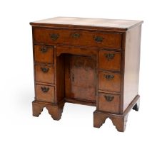 A George II Walnut Bureau-Table, 2nd quarter 18th century, the moulded top with re-entrant corners