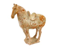 A Chinese Terracotta Horse, Tang Dynasty, standing four-square wearing a saddle, on a rectangular