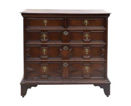 A Late 17th Century Joined Oak Chest, the moulded top above two short and three long geometric-