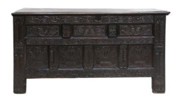 A 17th Century Joined Oak Chest, initialled WMA and dated 1602, the boarded hinged lid enclosing a
