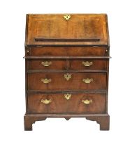 A George II Walnut, Crossbanded and Featherbanded Bureau, 2nd quarter 18th century, the fall front