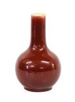 A Chinese Sang de Boeuf Glazed Porcelain Bottle Vase, Qing Dynasty, of ovoid form with cylindrical