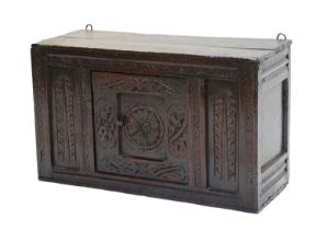 A Late 17th Century Joined Oak and Carved Food Cupboard, the boarded top above a central moulded