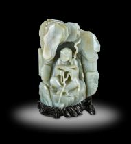 ~ A Chinese Celadon Jade Inscribed “Luohan” Boulder, Qianlong, carved with Ańgaja in a grotto,