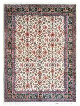 Indian Carpet, circa 1980 The ivory ground with an allover design of flowers enclosed by olive green