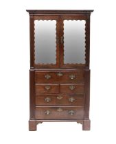 A George II Mahogany Secretaire Cabinet, circa 1760, the dentil cornice above later mirrored doors