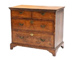 A George II Walnut, Crossbanded and Featherbanded Straight-Front Chest of Drawers, 2nd quarter