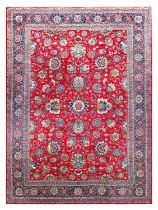 Kashan Carpet Central Iran, circa 1940 The raspberry field of large palmettes and flowerheads