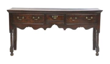 A George II Oak Open Dresser, mid 18th century, the boarded top above three pine-lined drawers and a