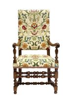 An Early 18th Century French Turned Walnut Open Armchair, recovered in modern floral crewelwork-