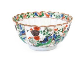 A Chinese Porcelain Bowl, Kangxi, of fluted circular form, painted in famille verte enamels with