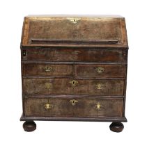 A George I Walnut, Featherbanded and Crossbanded Bureau, circa 1720, the fall front enclosing a