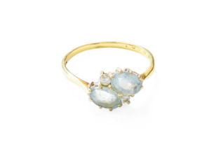 An 18 Carat Gold Aquamarine and Diamond Ring, two oval cut aquamarines with round brilliant cut