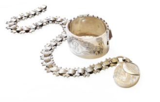A Victorian Silver Locket on Chain, the oval locket engraved to depict a bird amongst foliage, on