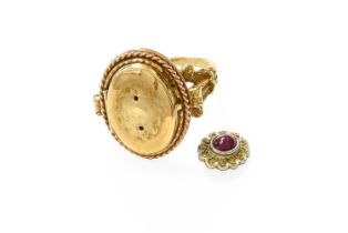 A 9 Carat Gold Cabochon Ruby and Diamond Cluster Locket Ring, the central cluster laid upon a