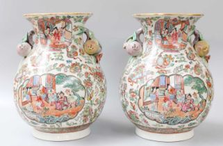 A Pair of Cantonese Porcelain Vases, 20th century, with fruit moulded handles, painted in famille