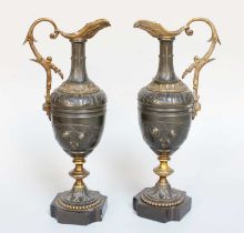 A Pair of Parcel Gilt Bronze Ewers, 19th century, of neo-classical style, decorated with stylized