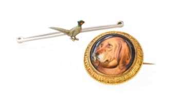 A Victorian Ceramic Brooch, the domed ceramic panel painted to depict a bloodhound, in a Greek key