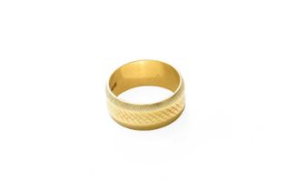 An 18 Carat Gold Textured Band Ring, finger size K1/2 Gross weight 5.6 grams.