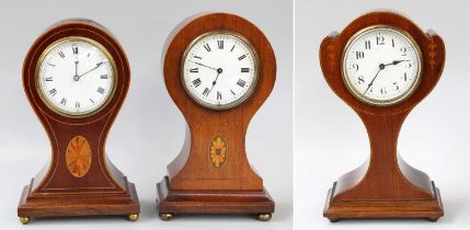 Three Edwardian Mahogany Inlaid Balloon Shaped Mantel Timepieces (3) Two timepieces are working