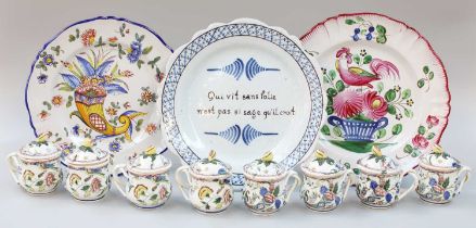 A French Faience Plate, painted with a cornucopia of flowers; together with a similar inscribed