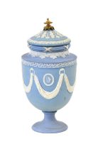 A Wedgwood Pale Blue Jasperware Pedestal Urn and Cover, early 19th century, with gilt metal knop,