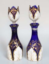 A Pair of Bohemian White Overlay Blue Glass Bottles and Stoppers, 19th century, 22 cm high