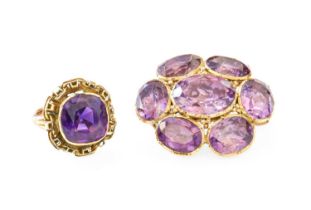 A 9 Carat Gold Amethyst Cluster Brooch, the central oval cut amethyst within a border of further