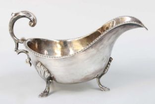 A George V Silver Sauceboat, by Henry Wigfull, Sheffield, 1933, oval and on three shell-capped