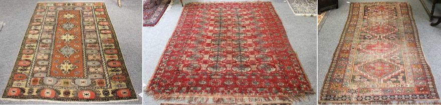 Kuba Rug, the field with a column of stepped medallions enclosed by madder hooked motif borders,