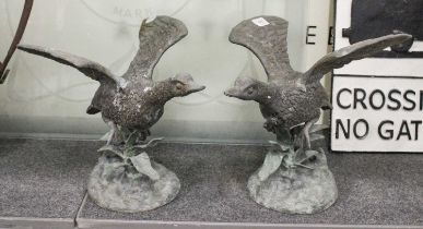 A Pair of Cast Metal and Patinated Garden Statues, formed as ducks taking flight, 30cm high