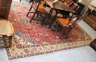 Tabriz Carpet, circa 1950, the faded brick red field of angular vines and plants around an indigo