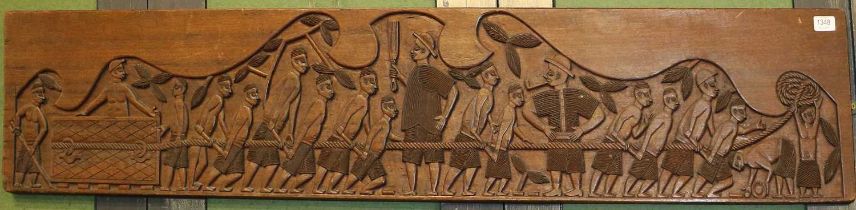 A 20th Century African Carved Wooden Panel, depicting slaves and overlords, 159cm by 29cm