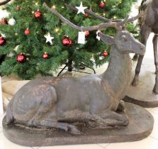 A Cast Metal Garden Statue, formed as a stag, laying recumbent on oval plinth, 80cm