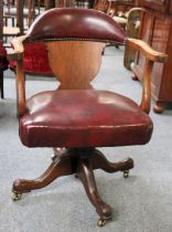 A Red Leather Oak Framed Swivelling Office Chair