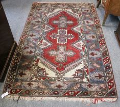 Dosemealti Rug, the brick red field with three cruciform medallions enclosed by steel blue borders