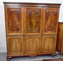 An Early 20th Century Triple Door Wardrobe, 190cm by 62cm by 199cm (excluding later fitted castors)