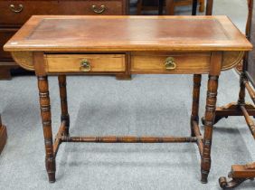 A Late Victorian Walnut Writing Table, with turned supports, 107cm by 54cm by 74cm Generally in good