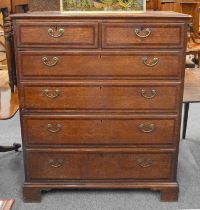 A George III Cross-Banded Oak Five Height Straight Front Chest of Drawers, 111cm by 58cm by 132cm