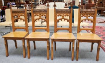 A Set of Four Gothic Style Blonde Oak Panelled Chairs of pegged construction Chair seats with some
