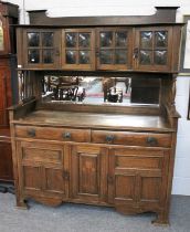 An Oak Arts & Crafts Dresser, the raised superstructure with cushioned glass doors over spindle