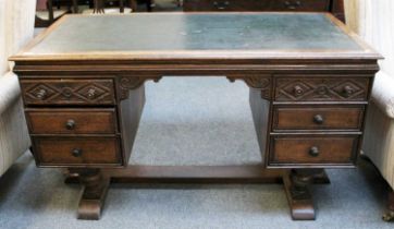 An Early 20th Century Carved Oak Desk, 138cm by 71cm by 77cm