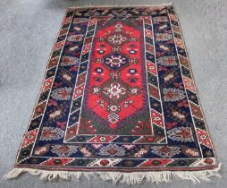 Dosemealti Rug, the crimson field with three latch-hook medallions enclosed by wide borders of