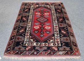 Dosemealti Rug, the raspberry lozenge field with latch-hook medallion framed by indigo borders,