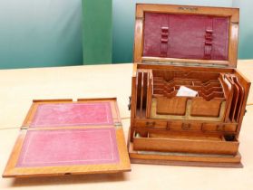 An Early 20th Century Oak Desktop Stationery Cabinet, with hinged top and fall front opening to